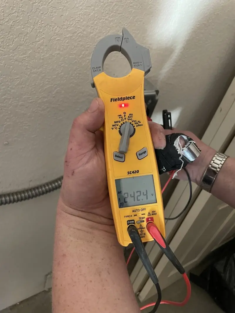 Voltage testing with clamp meter during Electrical Installation Services in Medulla